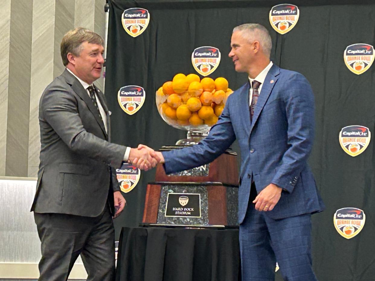 Georgia football coach Kirby Smart and Florida State coach Mike Norvell shake hands for the cameras after an Orange Bowl press conference on Dec. 29, 2023