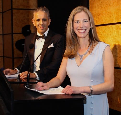 Imran Mahmood in a black suit with white shirt and Victoria Selman in a white dress