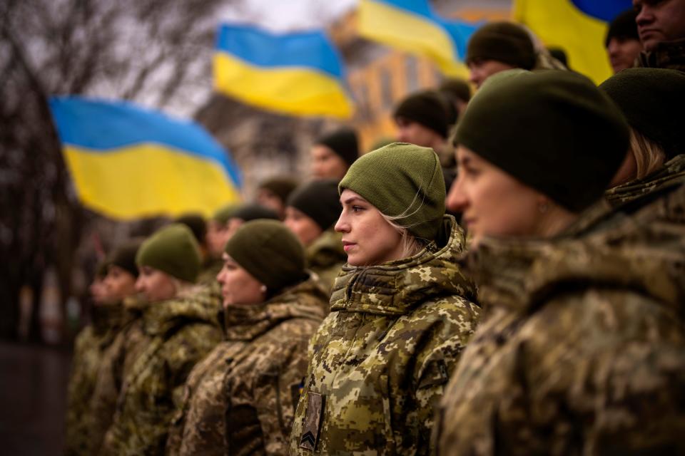 Ukrainian Army soldiers pose for a photo as they gather to celebrate a Day of Unity in Odessa, Ukraine, Wednesday, Feb. 16, 2022.