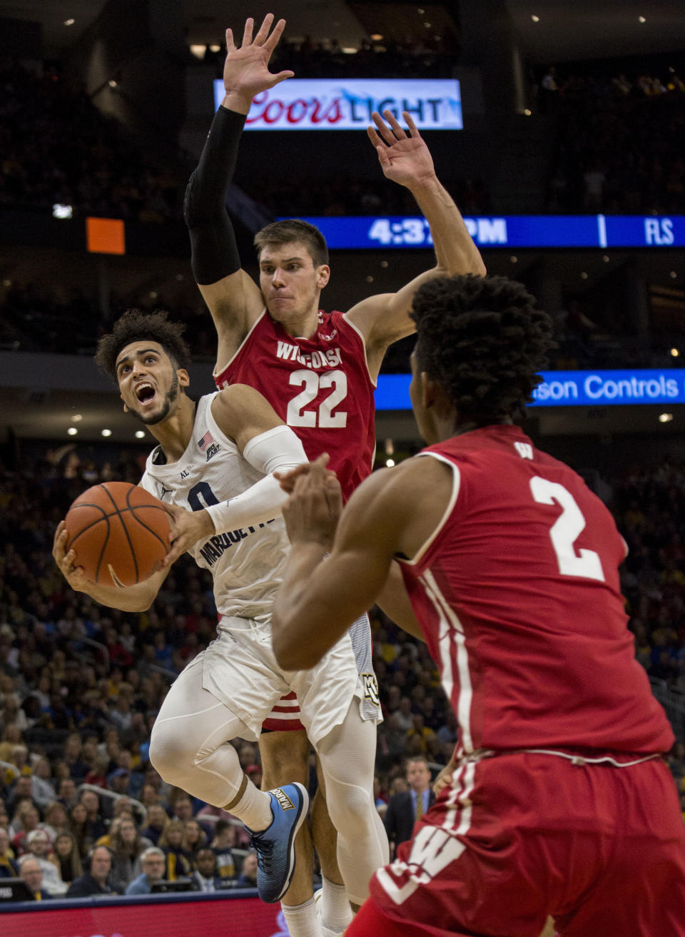 Marquette guard Markus Howard, left, is defended by Wisconsin during the first half of an NCAA college basketball game Saturday, Dec. 8, 2018, in Milwaukee. (AP Photo/Darren Hauck)