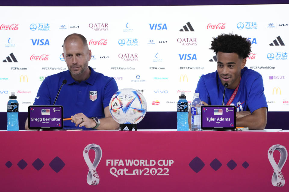 Head coach Gregg Berhalter, left, and Tyler Adams, both of the United States, attend a press conference on the eve of the group B World Cup soccer match between England and the United States, in Doha, Qatar, Thursday, Nov. 24, 2022. (AP Photo/Ashley Landis)