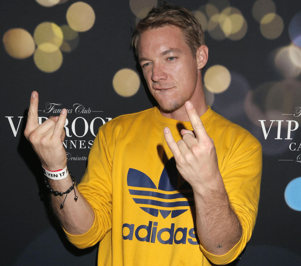 FILE - In this May 17, 2013 file photo, DJ Diplo arrives at the Belvedere Vodka Party in Cannes, southern France. TomorrowWorld organizers are taking extra precaution to maintain a safe environment for concertgoers this weekend after two drug-related deaths occurred at a similar festival in New York earlier this summer. Top EDM acts from Avicii, David Guetta to Diplo are among 300 internationally renowned DJs and performers that will take to eight different stages at the three-day festival that kicks-off in South Fulton County in suburban Atlanta on Friday, Sept. 27, 2013. (Photo by Todd Williamson/Invision/AP, File)