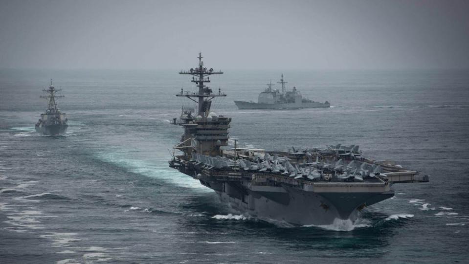 The aircraft carrier USS Theodore Roosevelt (CVN 71), front, the Arleigh Burke-class guided-missile destroyer USS Russell (DDG 59), left, and the Ticonderoga-class guided-missile cruiser USS Bunker Hill (CG 52), transit in formation