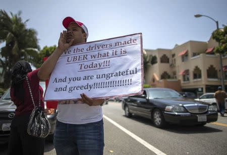 Uber driver Sam Salem, 29, protests with other commercial drivers with the app-based, ride-sharing company Uber against working conditions outside the company's office in Santa Monica, California June 24, 2014. REUTERS/Lucy Nicholson/File Photo