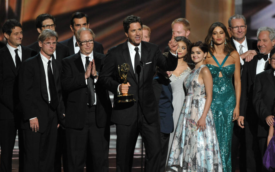 Steven Levitan, center, and the cast and crew of "Modern Family" accept the outstanding comedy series award at the 64th Primetime Emmy Awards at the Nokia Theatre on Sunday, Sept. 23, 2012, in Los Angeles. (Photo by John Shearer/Invision/AP)