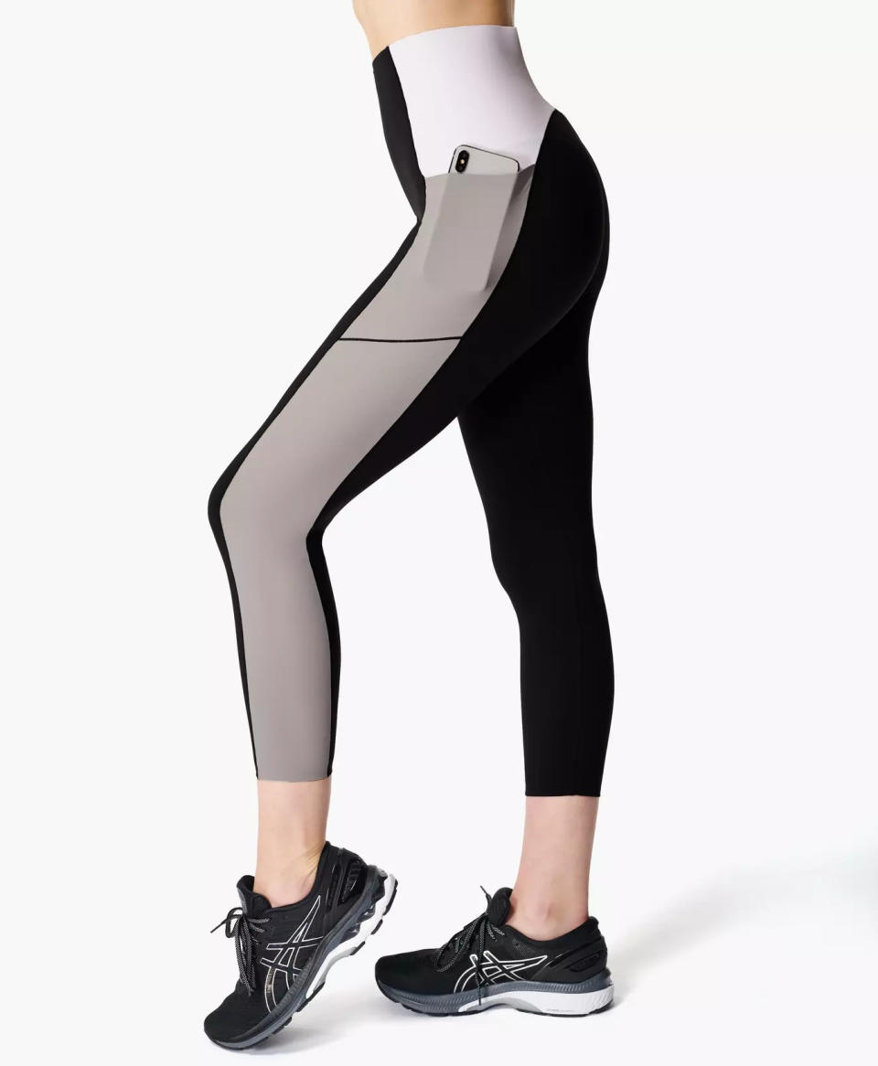 Person wearing black, gray and white leggings.