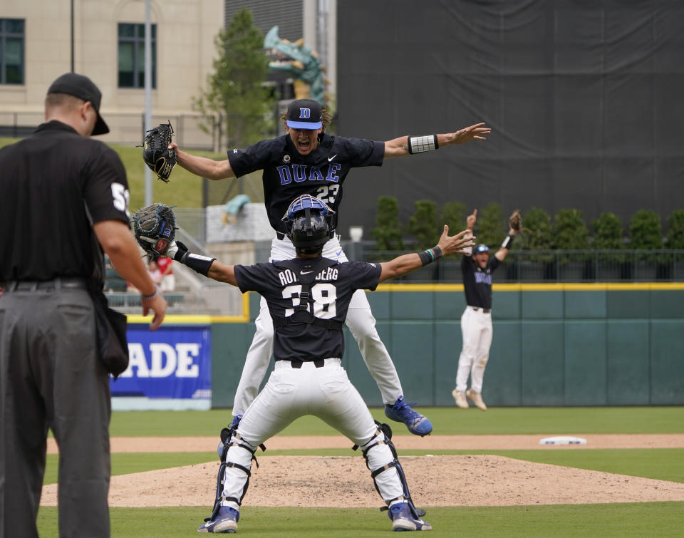 Duke pitcher Marcus Johnson, center top, celebrates with catcher Michael Rothenberg after their win over North Carolina State in an NCAA college baseball game during the Atlantic Coast Conference championship game on Sunday, May 30, 2021, in Charlotte, N.C. (AP Photo/Chris Carlson)