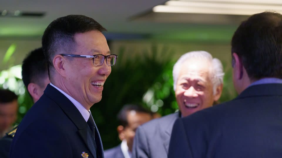 China's defense minister, Dong Jun (left) and  Singapore's defense minister, Ng Eng Hen (center) on the sidelines of the Shangri-La Dialogue in Singapore on June 1, 2024. - Ore Huiying/Bloomberg/Getty Images