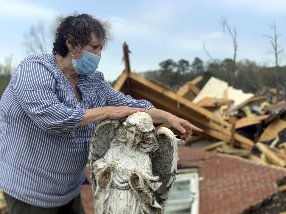 Mary Rose DeArman, 69, describes how she and her husband sheltered in a basement closet when a tornado struck their neighborhood in Shelby County, Alabama, Friday, March 26, 2021. The twister, which struck on Thursday, collapsed their brick home on top of them, but they escaped without serious injury. (AP Photo/Kim Chandler)