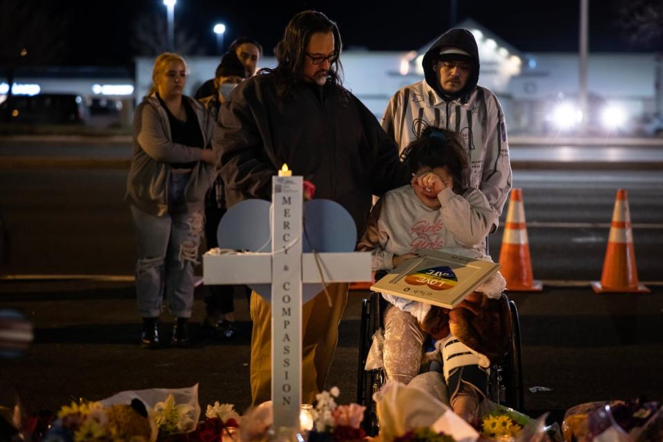 Richard Fierro consoles his daughter Kassandra on 22 November at a memorial for her boyfriend who was fatally shot during a mass shooting at Club Q in Colorado Springs. (Getty Images)