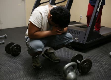 Raul Contreras, 19, of Honduras, who is seeking refugee status in Canada, works out at a gym at a long-stay hotel in Toronto, Ontario, Canada April 9, 2017. REUTERS/Chris Helgren