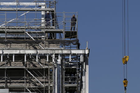 Laborers work at a construction site in Tokyo, Japan January 22, 2016. REUTERS/Toru Hanai