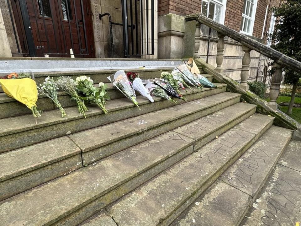 The words, ‘Love you all loads. Fly high’ were written on the stone staircase below a floral tribute at Shrewsbury College’s English Bridge campus (The Independent)