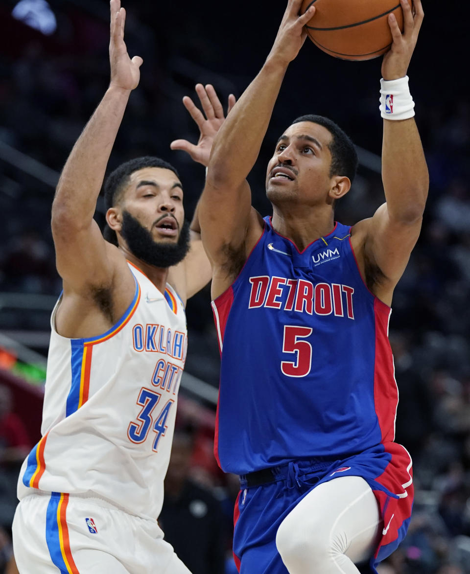 Detroit Pistons guard Frank Jackson (5) is defended by Oklahoma City Thunder forward Kenrich Williams (34) during the first half of an NBA basketball game, Monday, Dec. 6, 2021, in Detroit. (AP Photo/Carlos Osorio)