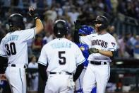 Arizona Diamondbacks' Jordan Luplow, right, celebrates his three-run home run against the Kansas City Royals with Alek Thomas (5) and Jake McCarthy (30) during the sixth inning of a baseball game Tuesday, May 24, 2022, in Phoenix. (AP Photo/Ross D. Franklin)