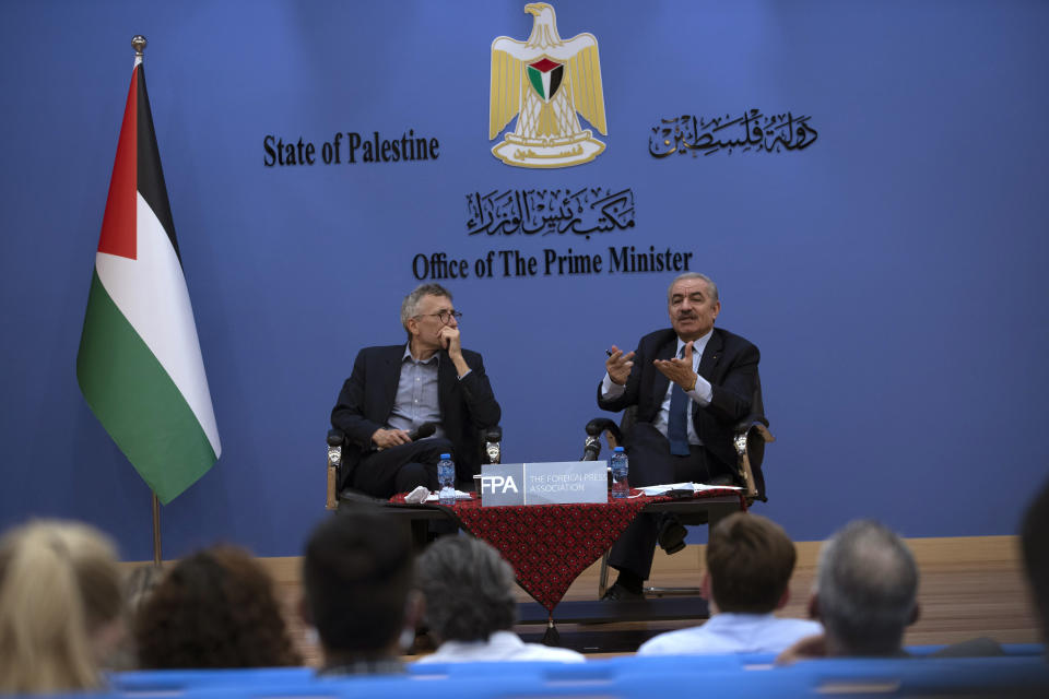 Palestinian Prime Minister Mohammad Shtayyeh, right, holds a briefing with foreign press alongside Andrew Carey, chairman of the Foreign Press Association (FPA), in the West Bank city of Ramallah, Wednesday, Nov. 10, 2021. (AP Photo/Majdi Mohammed)