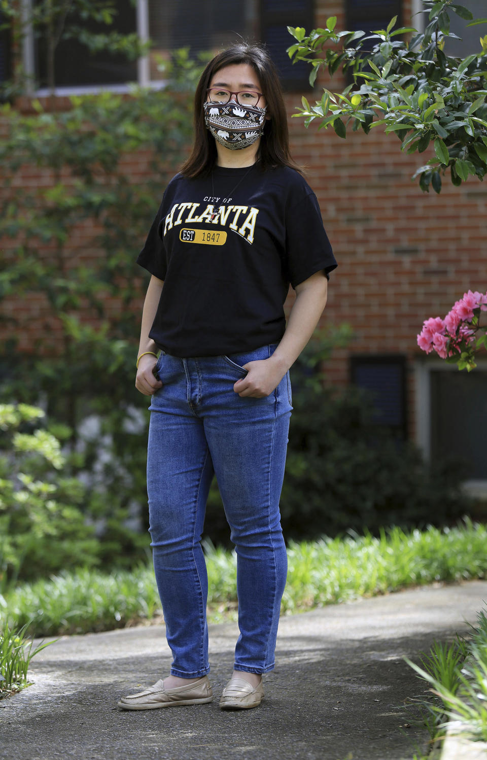 Claire Xu, poses for a photo, Friday, April 9, 2021, in Decatur, Ga., Xu was propelled into action following the mass fatal shootings of eight people, six of them Asian women, at a Georgia massage businesses in March. She organized a massive rally condemning violence against Asian Americans that drew support from a broad group of activists, elected officials and community members. But her own parents were opposed. (AP Photo/Akili-Casundria Ramsess)