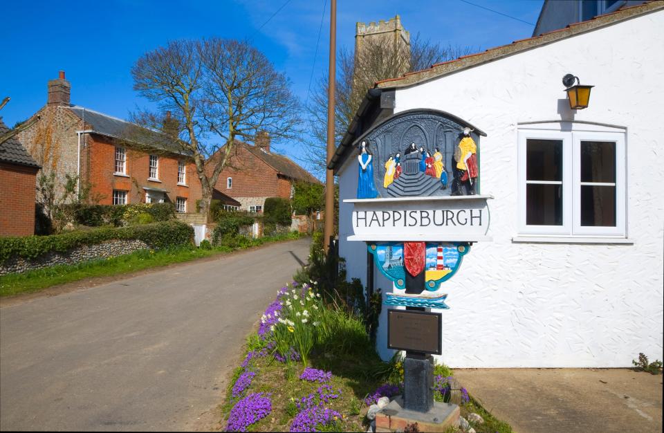 Village sign and houses, Happisburgh, Norfolk, England.