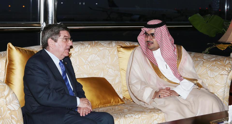 This image released by the Saudi Press Agency shows Prince Nawaf Faisal Fahd bin Abdul-Aziz, an International Olympic Committee member and president of the national Olympic committee, right,, walking with IOC President Thomas Bach, left, in Riyadh, Saudi Arabia, Wednesday, April 2, 2014. IOC President Thomas Bach has discussed the issue of women’s participation in sports with Saudi Arabia’s Olympic chief. The IOC says Wednesday that Bach promised “full support” for the country’s sports development strategy through 2020. The plan includes “proposals to increase women's participation in the Olympic Games and in sport in general.” Saudi women are largely banned from participating in sports in the kingdom, although there are several football and basketball clubs that play in clandestine leagues. After prolonged negotiations with the IOC, Saudi Arabia sent women to the Olympics for the first time in 2012, with two female athletes competing at the London Games. (AP Photo/Saudi Press Agency)