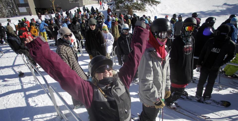 This Nov. 13, 2012 photo shows skiers gather in line for the chair lift during the first day of their ski season at the Brighton Ski Resort in the Wasatch Range, in Utah. The Brighton Ski Resort is in middle of the Wasatch Range's 7 resorts. If the resorts were to be combined, the Utah resorts could offer North America's largest skiing complex _ three times the size of Vail and twice as big as Whistler Blackcomb in British Columbia. (AP Photo/Rick Bowmer)