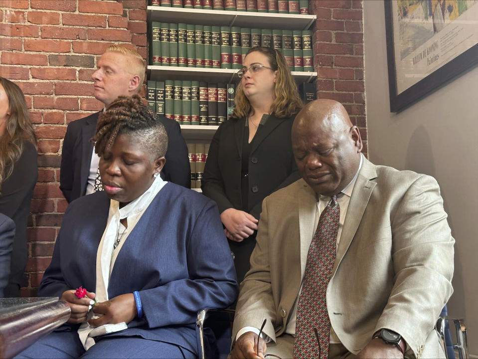 The parents of a teen who died after eating a spicy chip, Lois and Amos Wolobah, participate in a press conference announcing the filing of a lawsuit in the case, Thursday, July 11, 2024, in Boston. Harris Wolobah, a 10th grader from the city of Worcester, died Sept. 1, 2023, after eating the Paqui chip as part of the manufacturer’s “One Chip Challenge.” (AP Photos/Michael Casey)