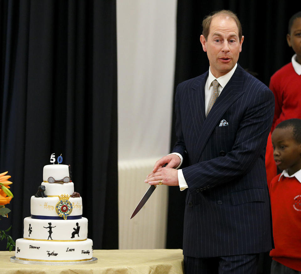 Prince Edward, pictured here cutting a cake in 2014, has been mocked for his technique. [Photo: Getty]