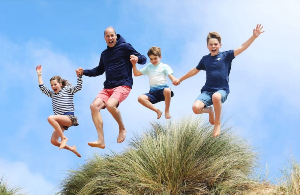 Catherine, Princess of Wales has posted a snap of Prince William leaping over sand dunes with their three children to mark his 42nd birthday credit:Bang Showbiz