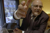 FILE - In this image from video, a man who identified himself as Michel Lambert, a director at the Paris-based agricultural technology firm CPW-Consulting, reacts during an interview at a restaurant in New York on Thursday, Jan. 24, 2019. Days after this video was broadcast, the Israeli investigative television show Uvda and The New York Times reported that Lambert was Aharon Almog-Assouline, a former Israeli security official living in the tony Tel Aviv suburb of Ramat Hasharon. (AP Photo/Joseph Frederick)