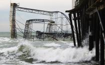 SEASIDE HEIGHTS, NJ - NOVEMBER 16: Waves break around a destroyed roller coaster on November 16, 2012 in Seaside Heights, New Jersey. Two amusement piers and a number of roller coasters in the seaside town were destroyed by Superstorm Sandy. (Photo by Mario Tama/Getty Images)