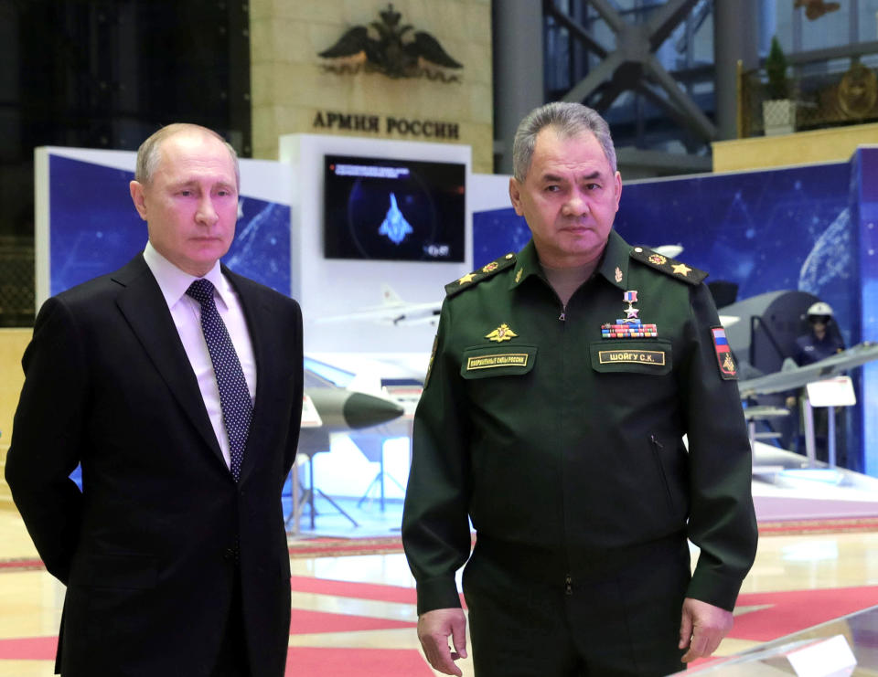 Russian President Vladimir Putin, left, and Defense Minister Sergei Shoigu speaks to journalists after attending an annual meeting with top military officials in the National Defense Control Center in Moscow, Russia, Tuesday, Dec. 24, 2019.Putin said that Russia is the only country in the world that has hypersonic weapons even though its military spending is a fraction of the U.S. military budget. (Mikhail Klimentyev, Sputnik, Kremlin Pool Photo via AP)