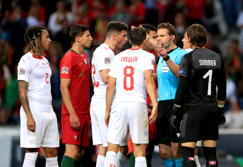 Referee Felix Brych speaks to the players whilst checking the VAR during the Nations League Semi Final (Photo by Mike Egerton/PA Images via Getty Images)
