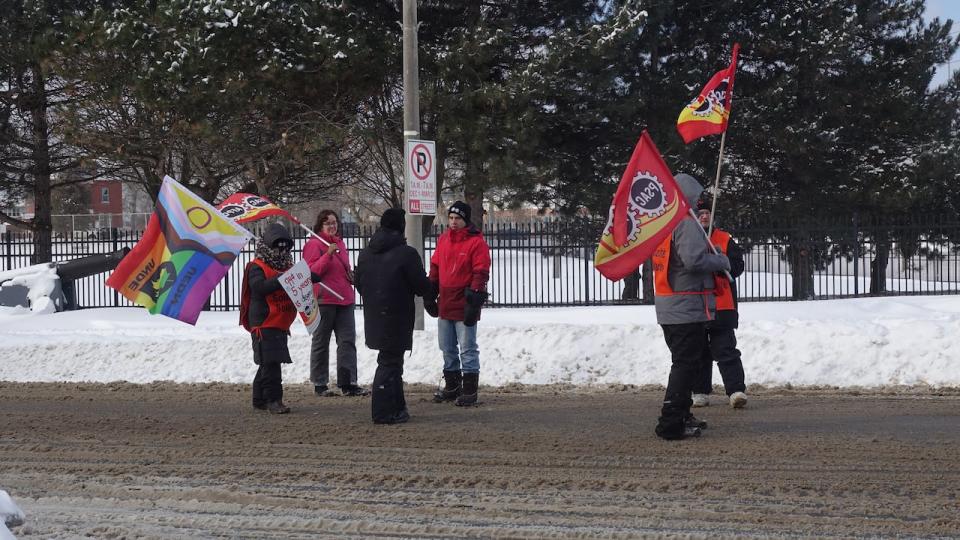 Striking Union Of National Defence Employees workers walk the picket line at the Royal Military College of Canada on Jan. 15, 2024.