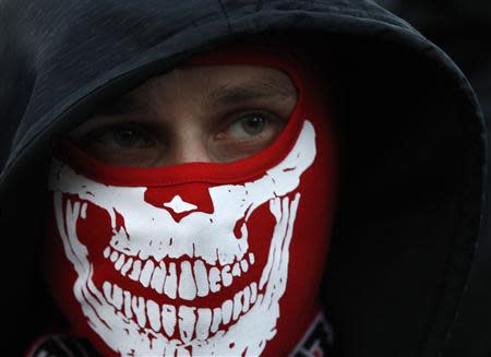 A far-right protester with a covered face takes part in an annual march, which coincides with Poland's National Independence Day in Warsaw November 11, 2013. REUTERS/Kacper Pempel