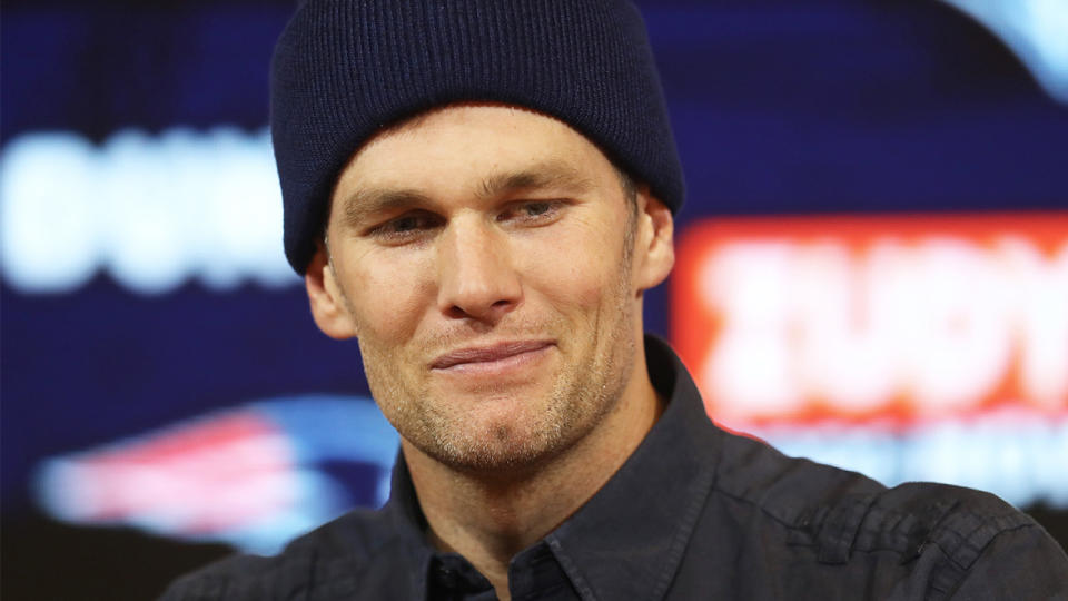 Tom Brady smiling in a media conference.