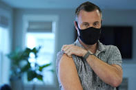 Neal Browning poses for a photo, Tuesday, March 9, 2021, in Bothell, Wash., north of Seattle. Earlier in the day, Browning, who was the second person to receive a shot nearly a year ago in the first-stage study of the Moderna COVID-19 vaccine, received a third shot as part of a new study of a one-year booster dose of the Moderna vaccine, which is now being widely used in worldwide vaccination efforts. Browning said that he has felt well since getting the third shot, except for some arm pain. (AP Photo/Ted S. Warren)