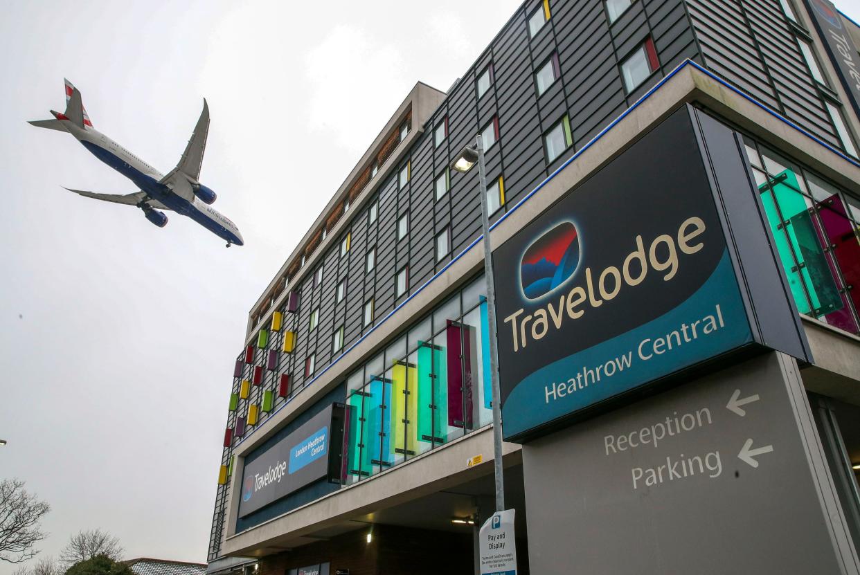 <p>A plane passes over the  Travelodge Hotel at Heathrow. </p> (PA)