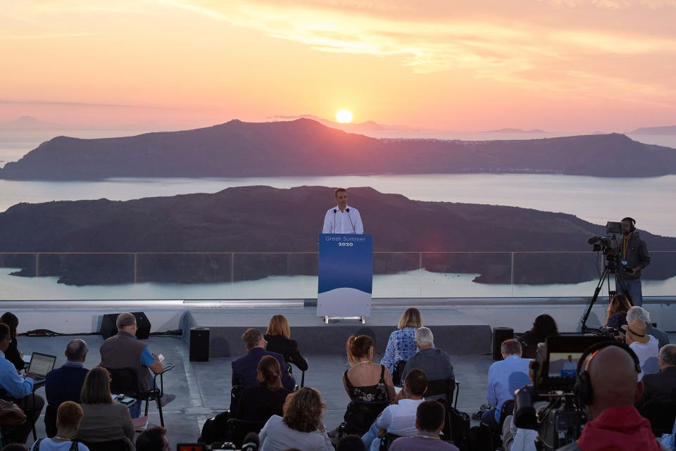 In this photo provided by the Prime Minister's Office, Greek Prime Minister Kyriakos Mitsotakis announces the opening of the tourist season during a news conference, on the Greek island of Santorini, Saturday, June 13, 2020. (Dimitris Papamitsos/Greek Prime Minister's Office via AP)