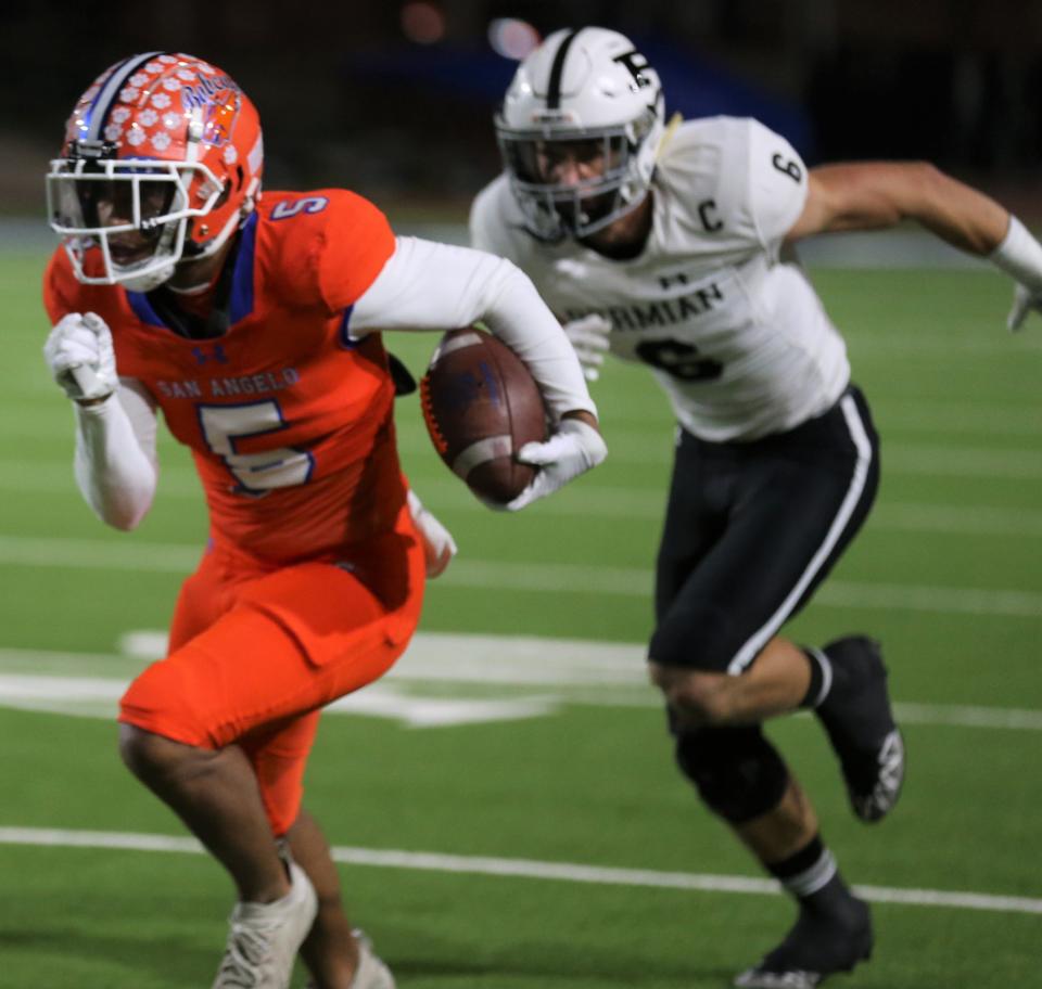 San Angelo Central High School wide receiver Keevon Rice, left, picks up hardage after making a catch against Odessa Permian at San Angelo Stadium on Friday, Oct. 28, 2022.