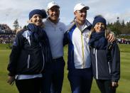 European Ryder Cup players Justin Rose (2nd R) and Henrik Stenson celebrate with their wives Kate (R) and Emma, after their victory in their fourballs 40th Ryder Cup match at Gleneagles in Scotland September 27, 2014. REUTERS/Russell Cheyne (BRITAIN - Tags: SPORT GOLF ENTERTAINMENT)