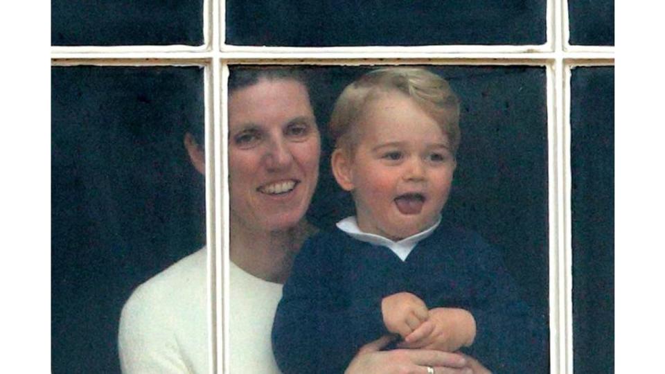 Prince George of Cambridge being held up at a window of Buckingham Palace by his nanny Maria Teresa Turrion Borrallo