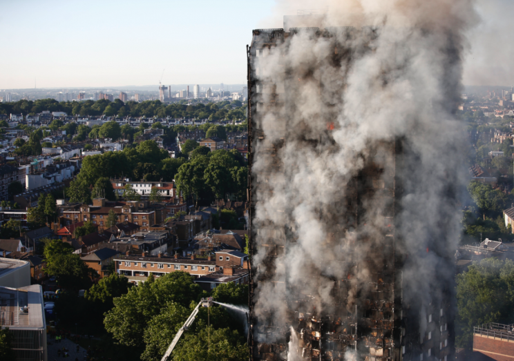 Smoke billows after the huge blast at the Grenfell Tower (SWNS)