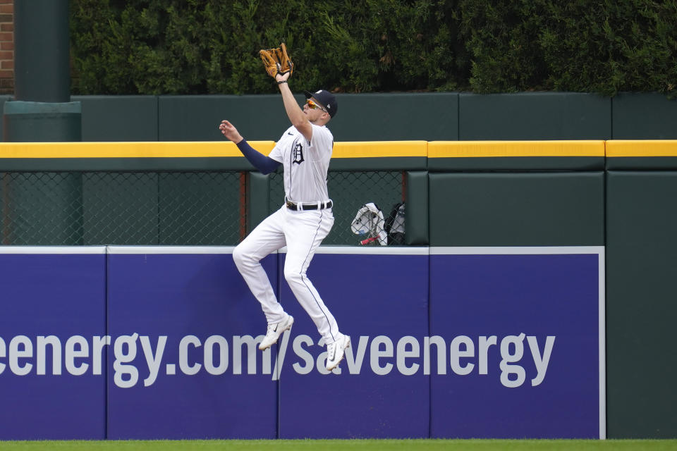 Detroit Tigers center fielder Parker Meadows (22) catches a Kansas City Royals' Nelson Velazquez fly ball at the outfield wall for the final out in the ninth inning of a baseball game that was suspended Wednesday night because of rain, Thursday, Sept. 28, 2023, in Detroit. (AP Photo/Paul Sancya)