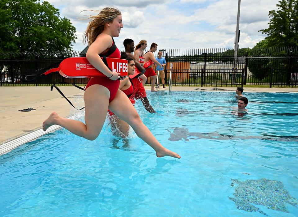 Last week, lifeguards jump into the Bennett Field Pool in Webster Square.