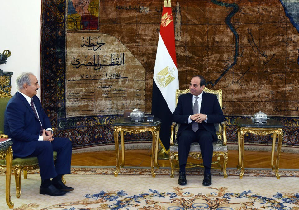 In this photo provided by Egypt's presidency media office, Egyptian President Abdel-Fattah el-Sissi, right, meets with the head of the self-styled Libyan National Army Field Marshal Khalifa Hifter in Cairo, Egypt, Sunday, April 14, 2019. Hifter launched a surprise offensive against Tripoli on April 5 and is battling rival militias loosely affiliated with a weak U.N.-backed government. (Egyptian Presidency Media office via AP)