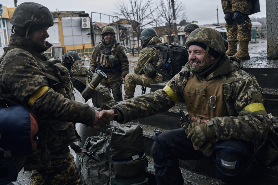 Ukrainian soldiers rest near their position in Bakhmut, Donetsk region, Ukraine, Saturday, Dec. 17, 2022. (AP Photo/LIBKOS)