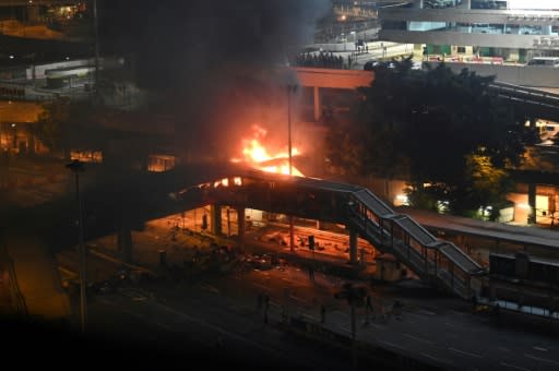 Police tried to retake a footbridge over a tunnel in Hong Kong�but were met by a barrage of petrol bombs that caused a huge fire