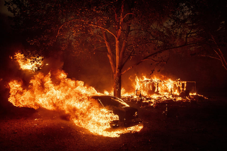 Flames from the Kincade Fire consume a home and car in the Jimtown community of unincorporated Sonoma County, Calif., Oct. 24, 2019. (AP Photo/Noah Berger)