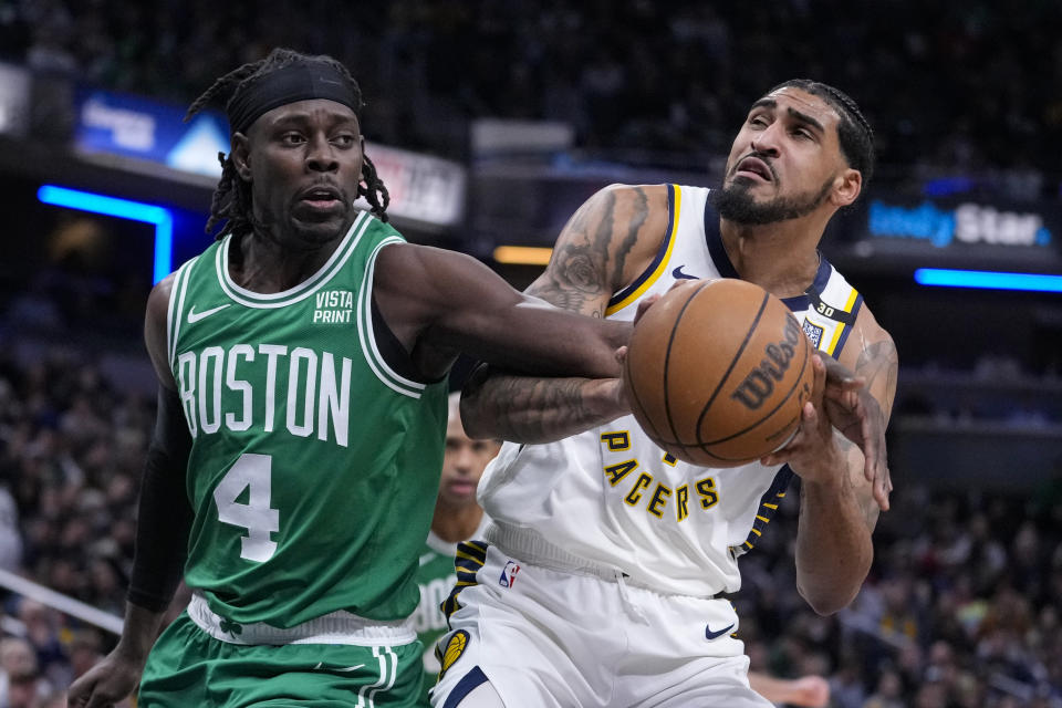 Indiana Pacers forward Obi Toppin (1) is fouled by Boston Celtics guard Jrue Holiday (4) during the first half of an NBA basketball game in Indianapolis, Monday, Jan. 8, 2024. (AP Photo/Michael Conroy)