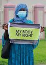 A protester carries a banner during a demonstration to raise awareness about sexual violence, in Abuja