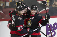 Ottawa Senators' Drake Batherson, center, celebrates his game winning goal against the Pittsburgh Penguins with Jake Sanderson, left, and Tim Stutzle following overtime in an NHL hockey game, Tuesday, March 12, 2024, Ottawa, Ontario. (Adrian Wyld/The Canadian Press via AP)